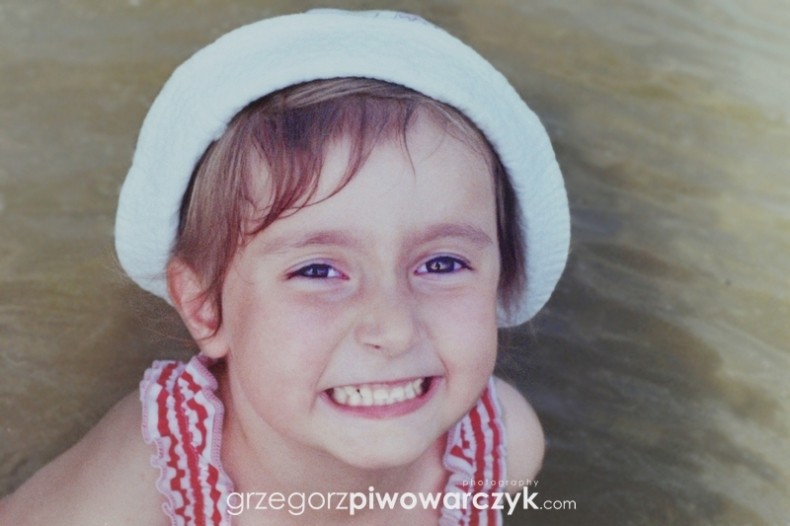 Fotograf dziecięcy. Uśmiech dziecka. Dziewczynka w kapeluszu na głowie. Fotografia dziecięca. Wrocław